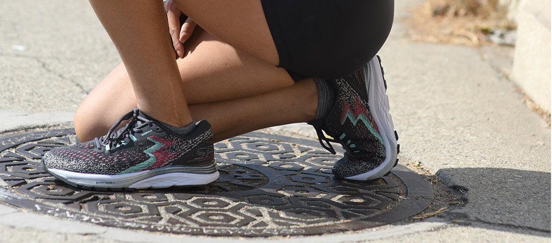 Close-up of woman kneeling women's 361 Spire 4 running shoes