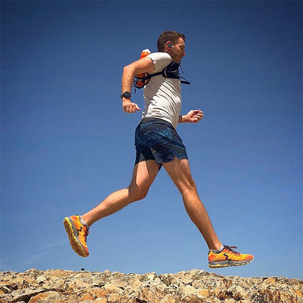 Man running outside with clear sky in men's 361 trail running shoes