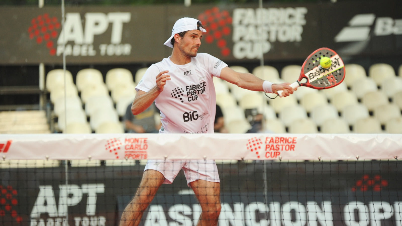 Man in mid-motion hitting padel ball