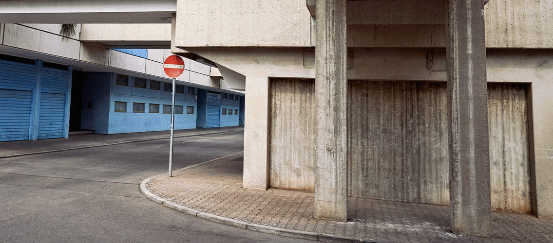 adidas' image of blue and white concrete buildings in city with red stop sign