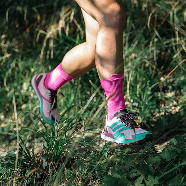 Close up of woman running in adidas Terrex trail running shoes