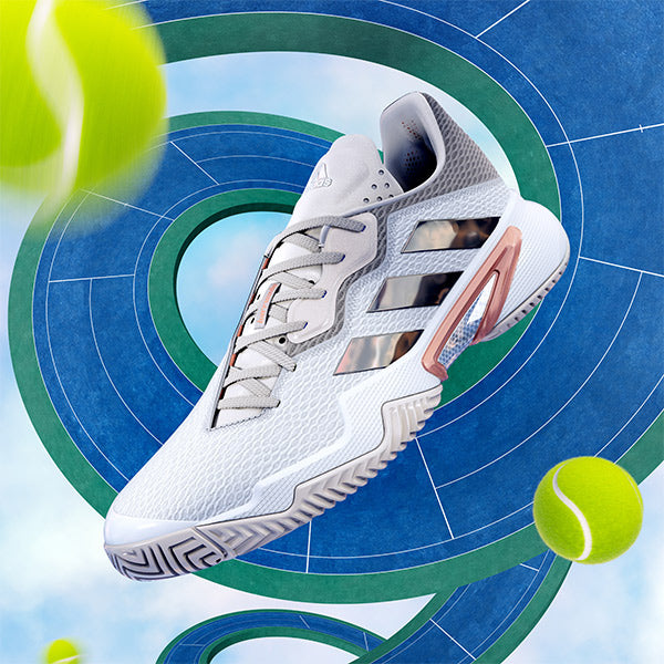 Single floating women's adidas tennis shoe against swirling tennis court and flying tennis balls