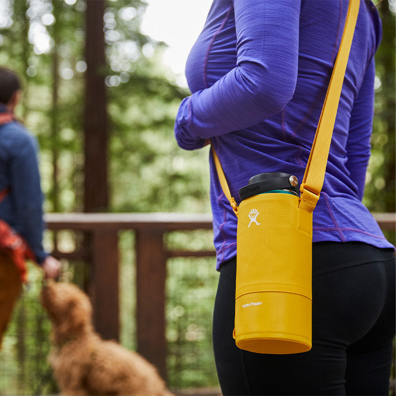 Woman wearing yellow hydro flask bottle sling