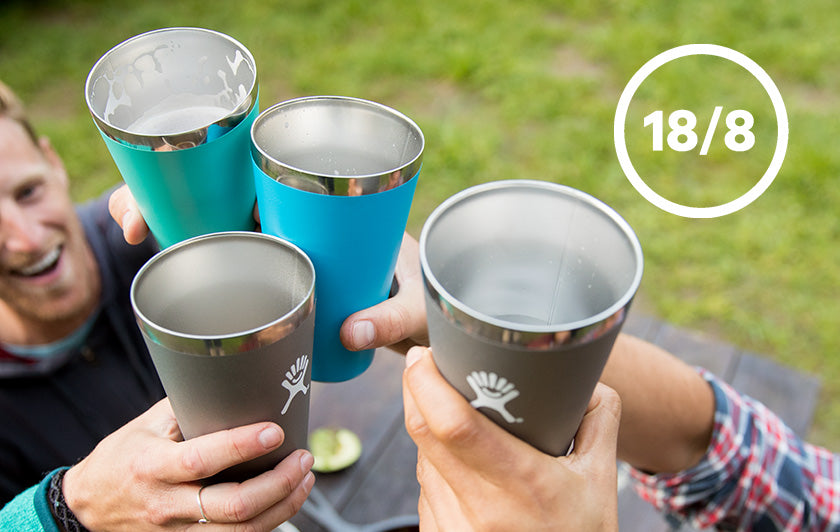 Overhead shot of friends making a toast with Hydro Flask bottle