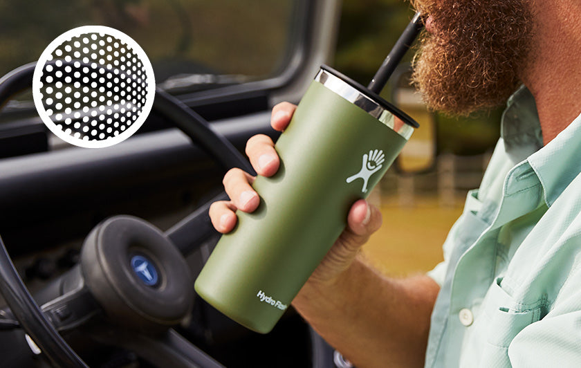 Man in car drinking from green Hydro Flask bottle
