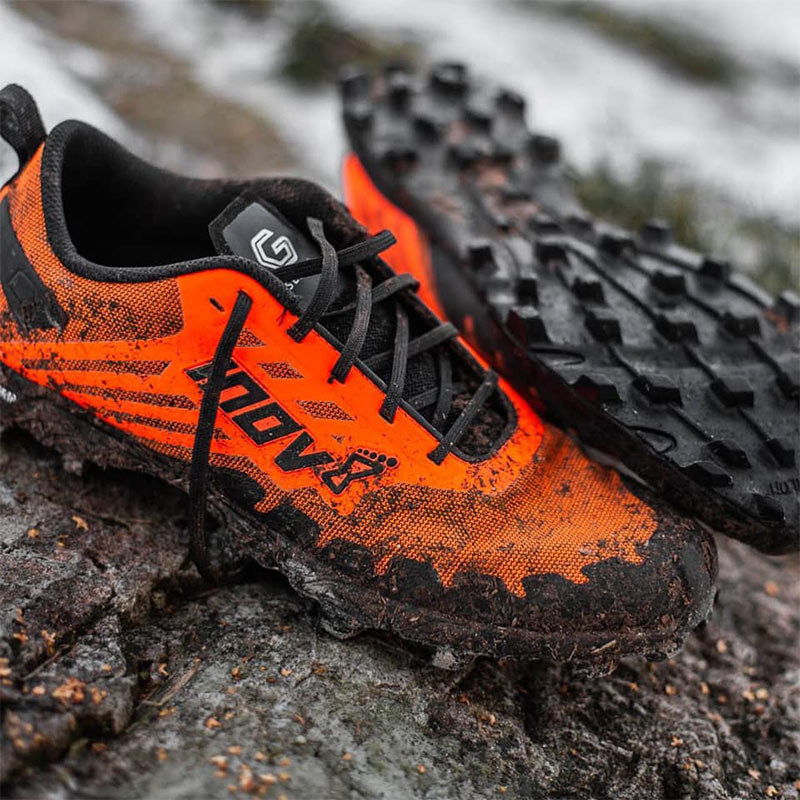 Close up of orange and black inov-8 Men's Trail Running Shoes