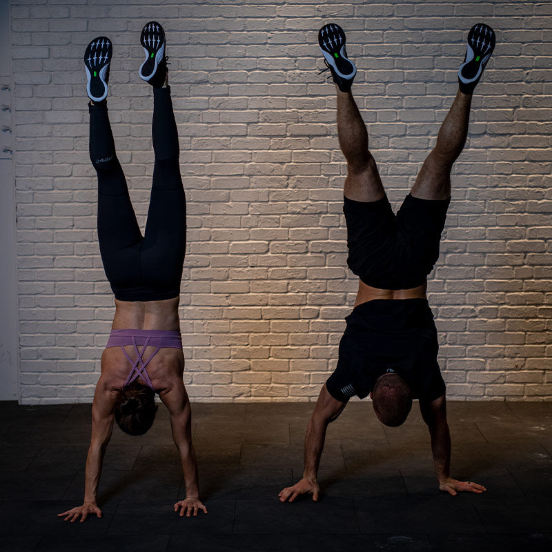 Man and woman doing handstands wearing inov-8 Training Shoes