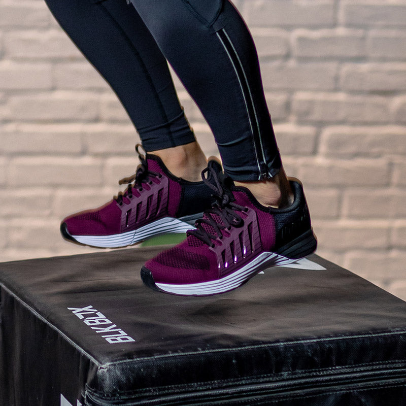 Woman on box jump in gym wearing inov-8 Women's Training Shoes