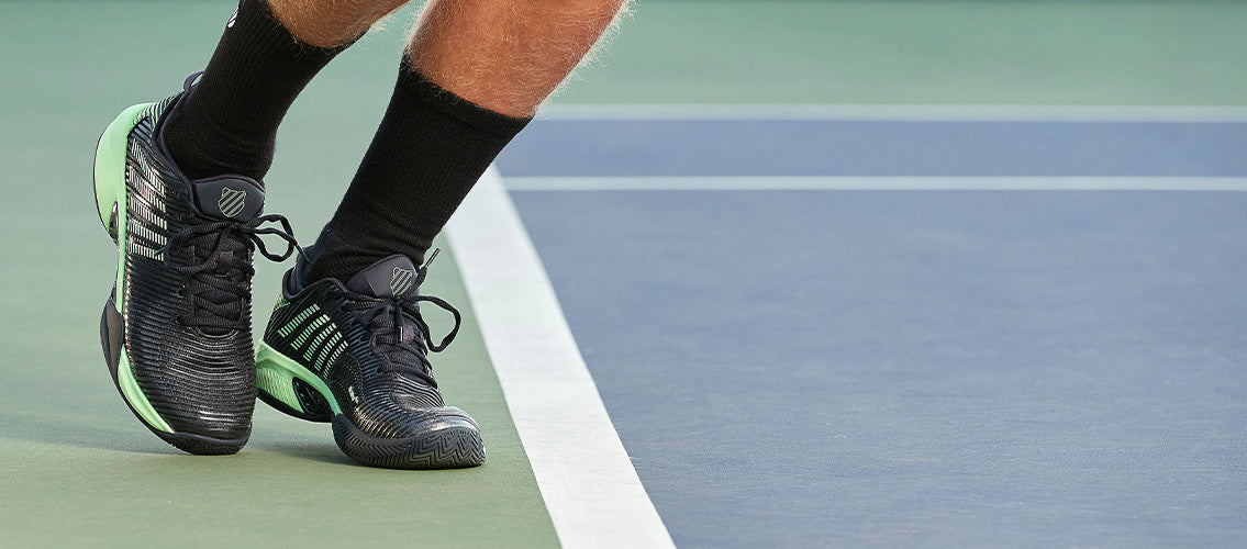 Man playing on court in K-Swiss tennis shoes