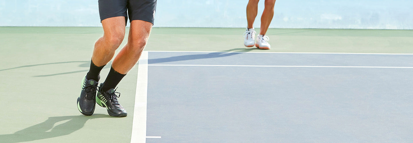 Man and woman on court in K-Swiss tennis shoes