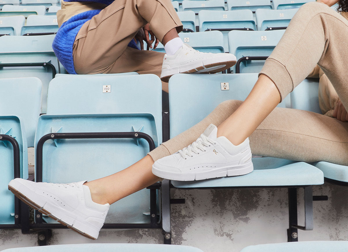Closeup of woman and man in bleachers weraing On The Roger Centre Court tennis shoes
