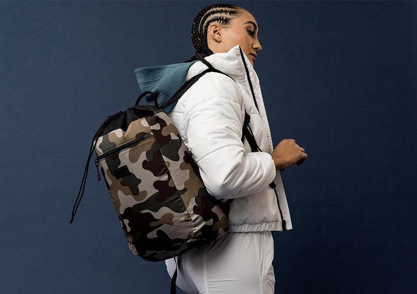 Woman wearing Vooray camo bag