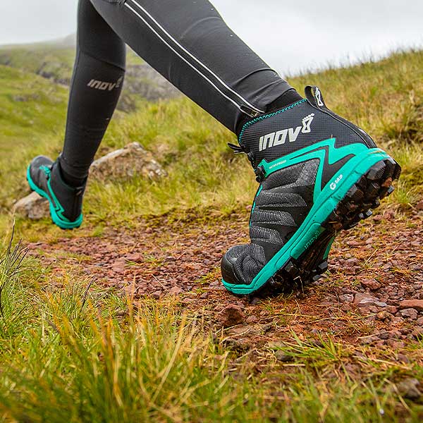 Woman on trail wearing inov-8 Women's Hiking Shoes