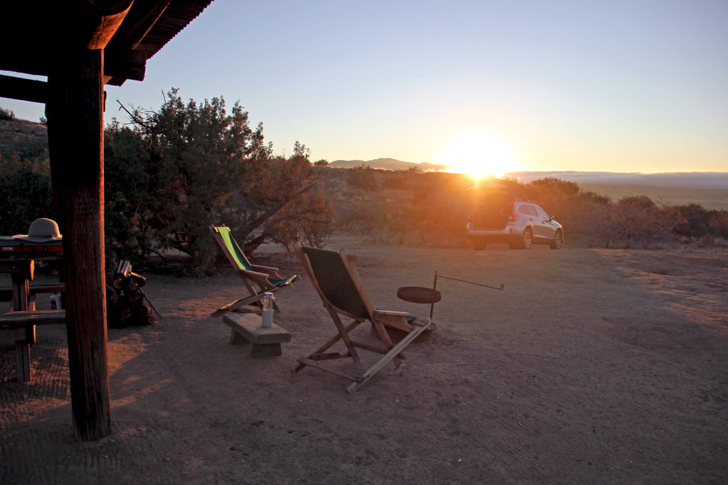 Sunset around a campfire and chairs