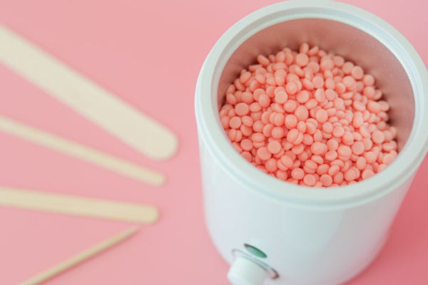 Facial wax warmer and pink hard wax beads