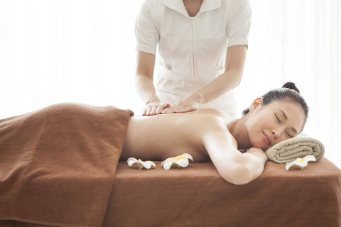 Spa therapist giving client a massage