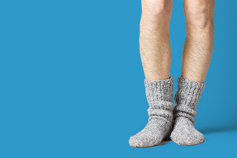 Person with hairy legs wearing cozy socks in the winter