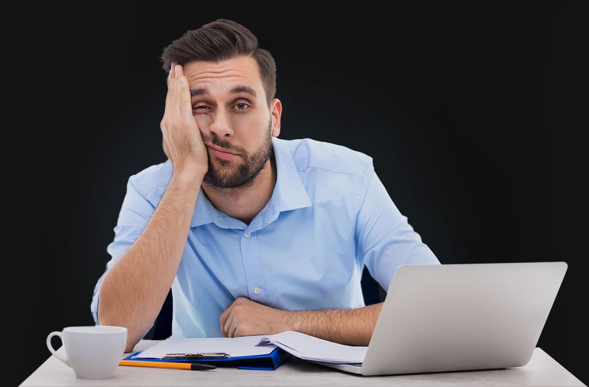 Man looking tired sitting in an office chair