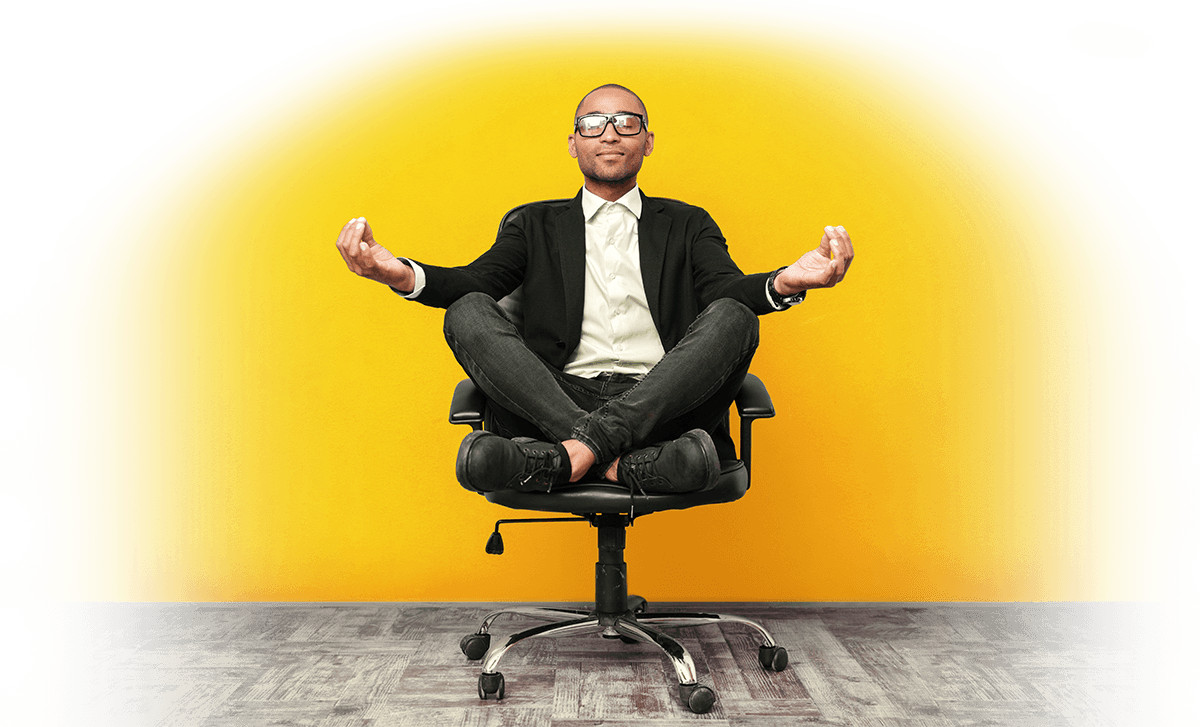 Man meditating in office chair in peace