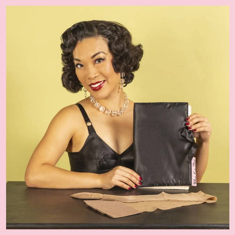 Sheer hosiery storage bag shown with contrast seamed stockings and black satin bullet bra.