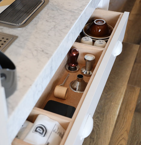 Tidy kitchen drawer with a white marble counter. Photograph by Dan Counsell