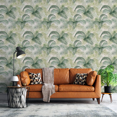 Palm leaves self-adhesive wallpaper behind a tan leather sofa