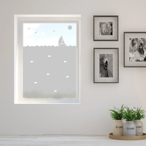 A bathroom window with sailboat design frosted window film