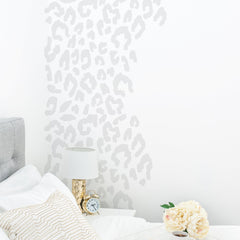 Grey leopard print wall stickers next to a bed