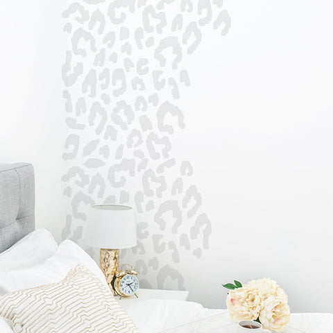 Leopard print wall stickers above a bed in a teenagers bedroom
