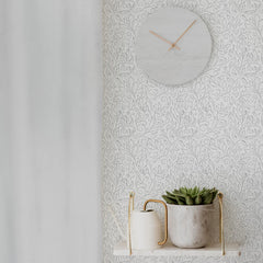 Floral monochrome self-adhesive wallpaper next to a white curtain