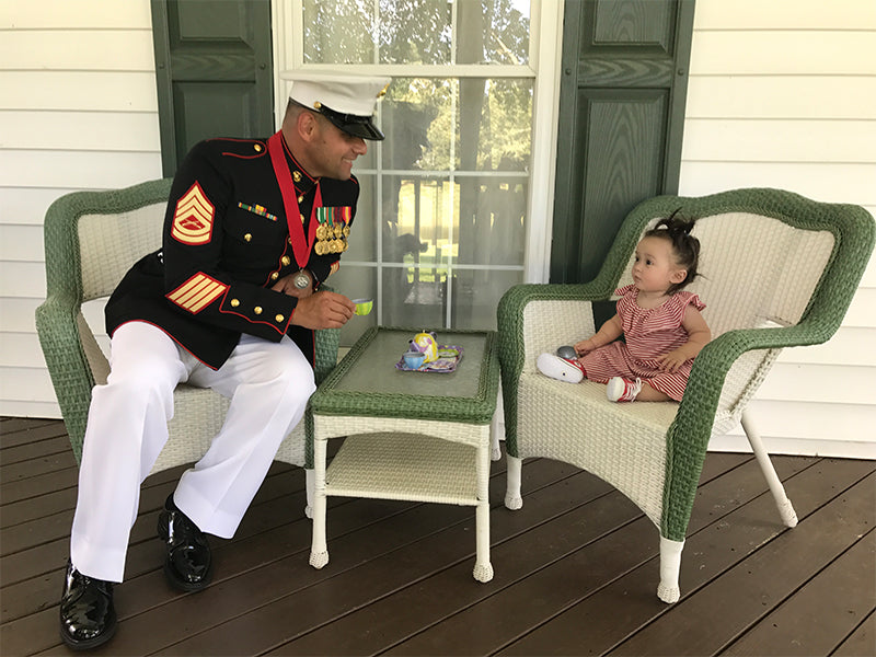 Gunnery Sergeant Mauricio Velasquez on Porch with Child