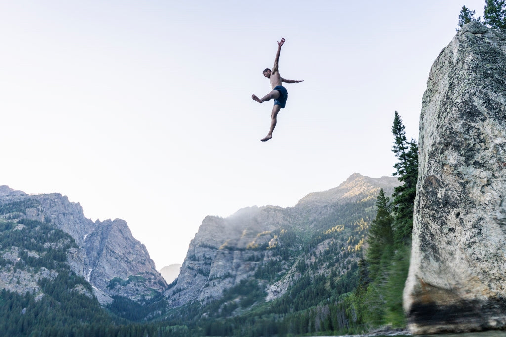 Dalton Johnson Jumping off a cliff, star-fishing into a lake with the Grand Tetons in the background 