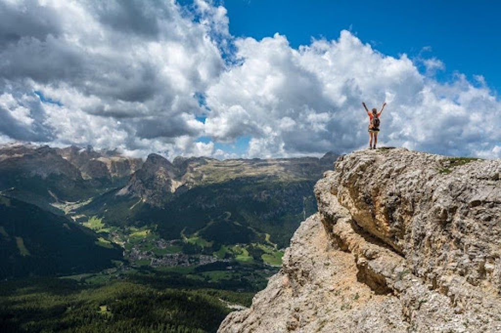 Person standing on mountain top 