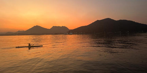 Lakes in Udaipur surrounded by the Aravalli mountain ranges at sunset.