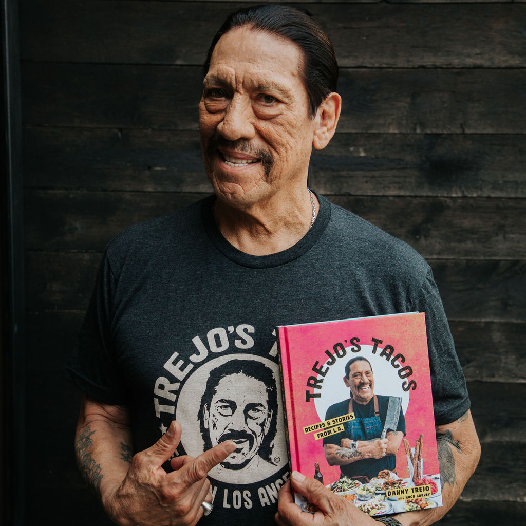 Danny Trejo holding a cookbook