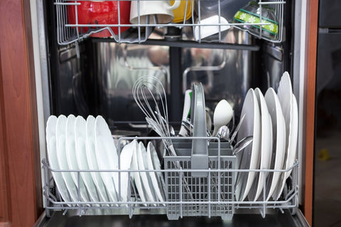 Home dishwashing machine loaded with cutlery