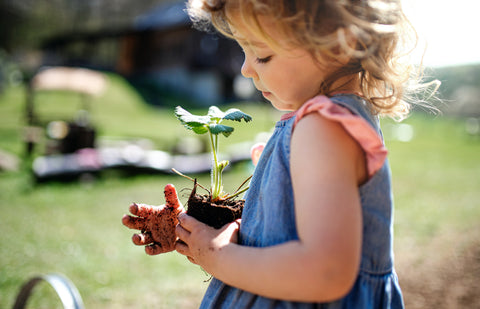 girl holding plant