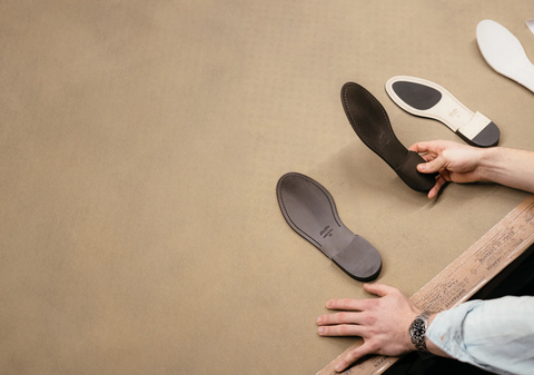 man holding a slipper sole