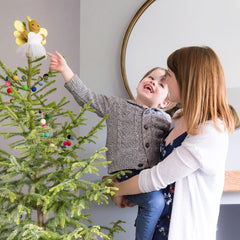Family traditions decorating a Christmas tree