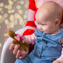 Baby's first Christmas ornament. Baby girl with personalised gingerbread man decoration 