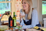 Jessica Bell with a HaloVino wine tumbler standing in her kitchen.