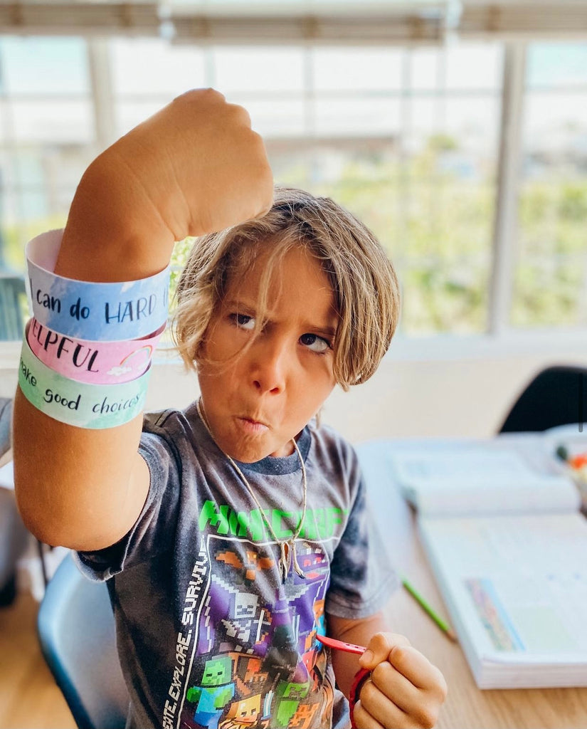 Child showing his Affirmation Bracelets hanging from his arm