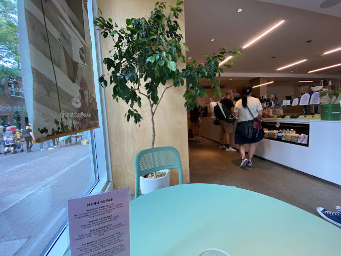 Spacious interior of Dispatch Coffee in downtown Montreal, showcasing multiple seating arrangements.