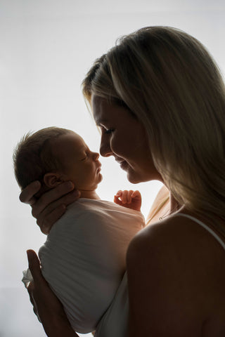 Tori holding Rainbow baby