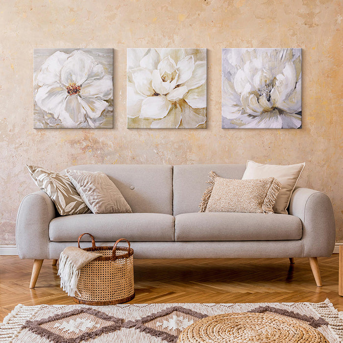 Three piece neutral floral set hanging above a couch.