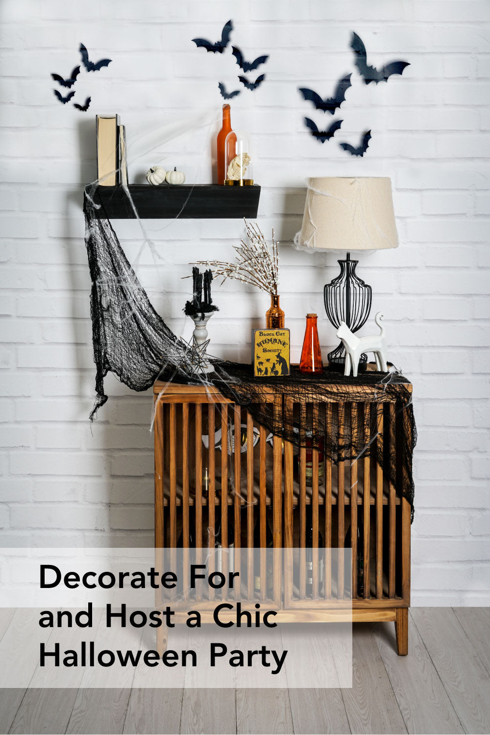 decorate for and host a chic halloween party graphic for pinterest. image of chic Halloween decorations on wood cabinet and black shelf