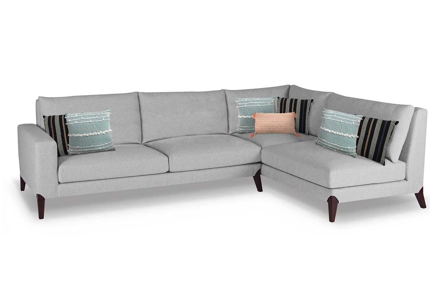 Grey Sectional couch with seven pillows two on either end and two in the middle with a third lumbar pillow 