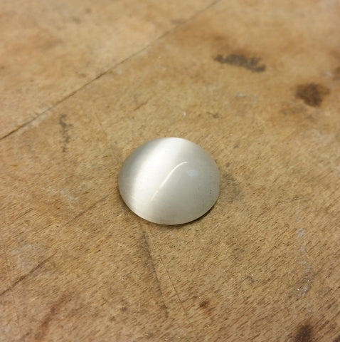 Christine Alaniz Designs white glass cabochon that shows chatocency