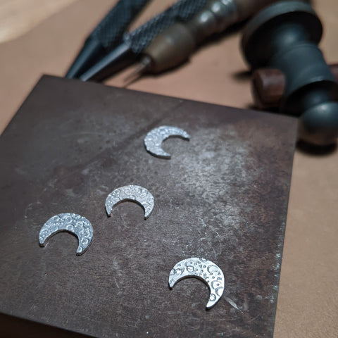 Sterling silver moons on a steel block 