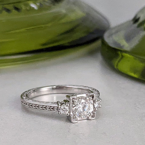 christine alaniz designs white gold ring with 3 diamonds and leaf engraving on the shank